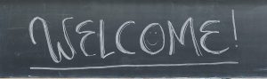 A welcome message is pictured written on a classroom chalkboard.